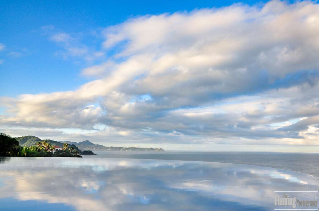 Infinity pool, overlooking ocean, bright blue sky and clouds, Banderas Bay, Nayarit, Mexico