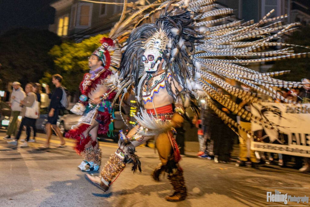 San Francisco, California, USA. 2nd November 2019. Aztec dancers perform at the 37th annual procession to honor and remember the dead in the Mission District of San Francisco.