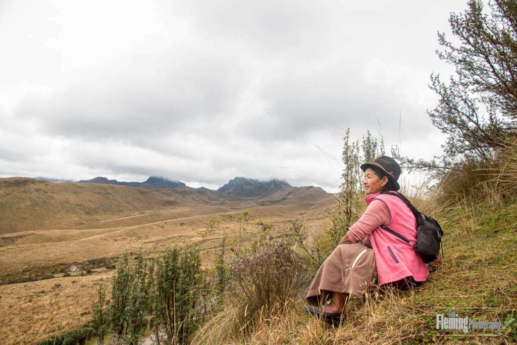 Indigenous woman looking out over the Paramo hills in the Andes near Quito, Ecuador