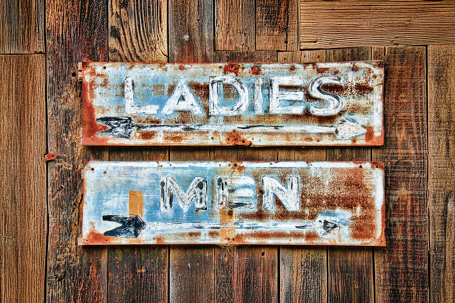 Weathered restroom signs on wood by tim fleming